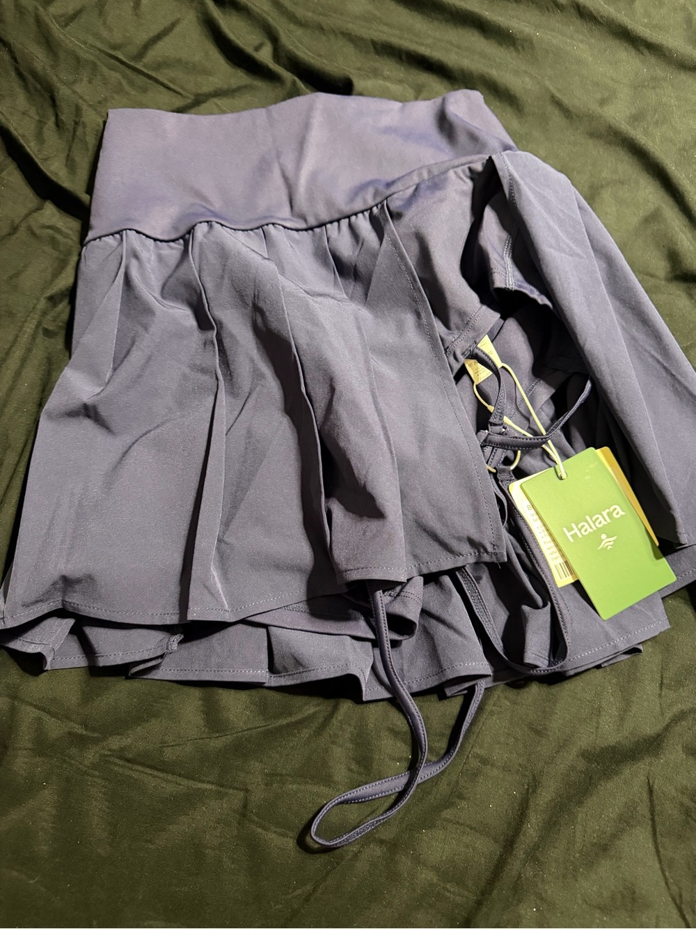 Two Halara breeze full mid rise belted mini skirts